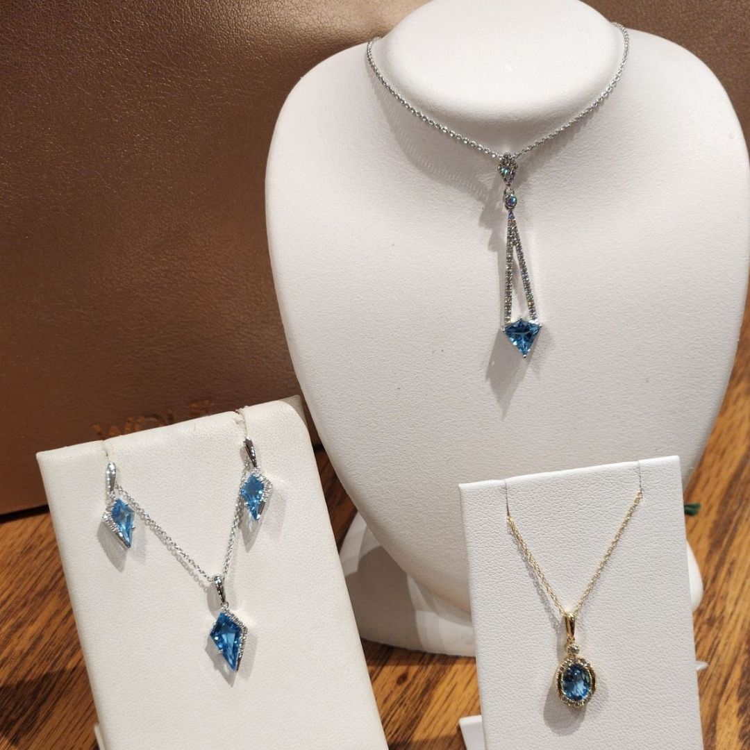 topaz and diamond necklaces displayed with white backdrop